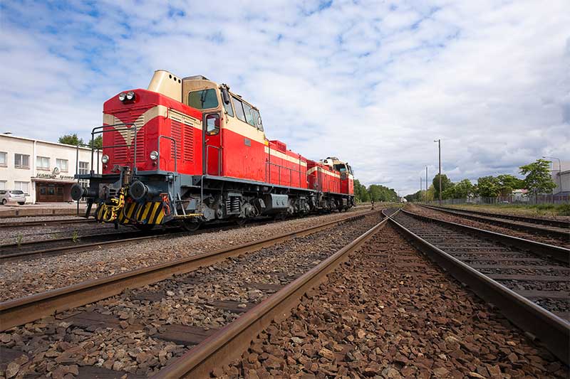 Aerial view of a red freight train on railway tracks, symbolizing logistics and transportation services in China by Vast Logistics.