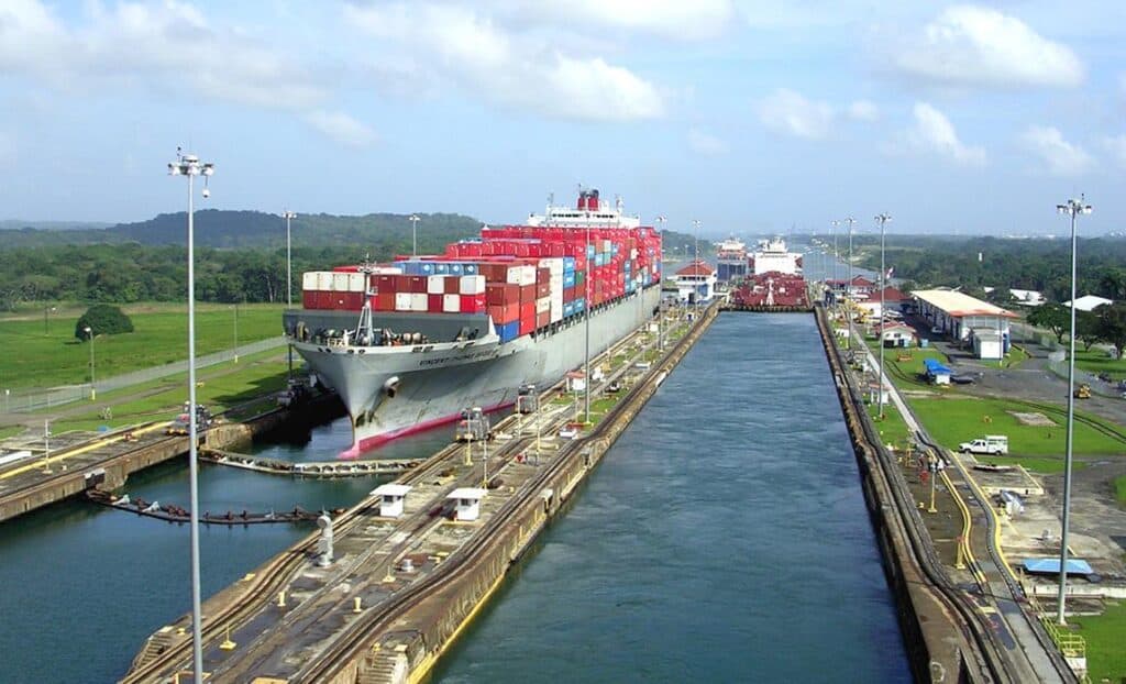 Container cargo ship in the Panama Canal, showcasing China Vast Logistics international shipping and freight forwarding services.