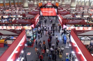 High-angle view of China Vast Logistics trade show booth displaying large machinery, industrial equipment, and logistics solutions at an international trade event.