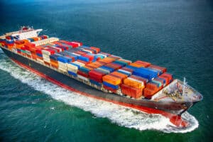 Cargo ship transporting shipping containers across the ocean, representing China Vast Logistics shipping and freight forwarding services.