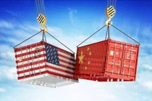 US and China flags on shipping containers being lifted by cranes, symbolizing international trade and logistics.
