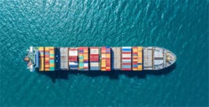 Container ship with colorful cargo containers sailing in open water for efficient logistics.