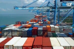 Shipping containers at China Vast Logistics port with cranes for sea freight transportation.