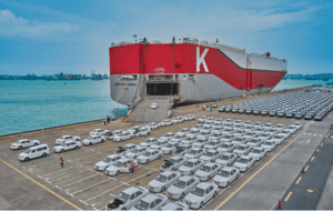 Large cargo ship docked at port with numerous vehicles being transported, showcasing China Vast Logistics' expertise in maritime freight and vehicle shipping services.