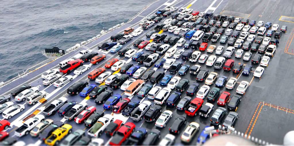 Large car parking lot by water showcasing logistics and transportation services in China Vast Logistics.