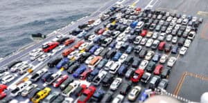 Large car parking lot by water showcasing logistics and transportation services in China Vast Logistics.