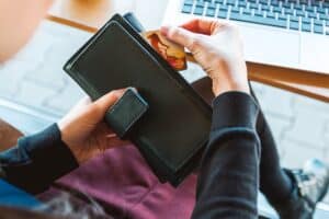 Wallet with credit card close-up, online shopping, e-commerce transactions, financial management, digital payments, and secure banking.