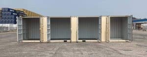 Four open shipping containers displayed in a row on a storage yard, beige and grey exterior, showing spacious interior for cargo storage and transport