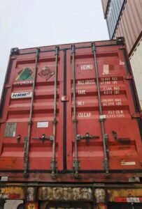 Heavy-duty red shipping container used for international freight logistics in China, featuring detailed weight and capacity labels, exemplifying Vast Logistics' expertise in supply chain management.