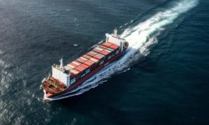 Container cargo ship navigating through open waters, representing global logistics and shipping services from China Vast Logistics.