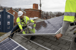 Solar panel installation on residential roof by construction workers, China Vast Logistics.