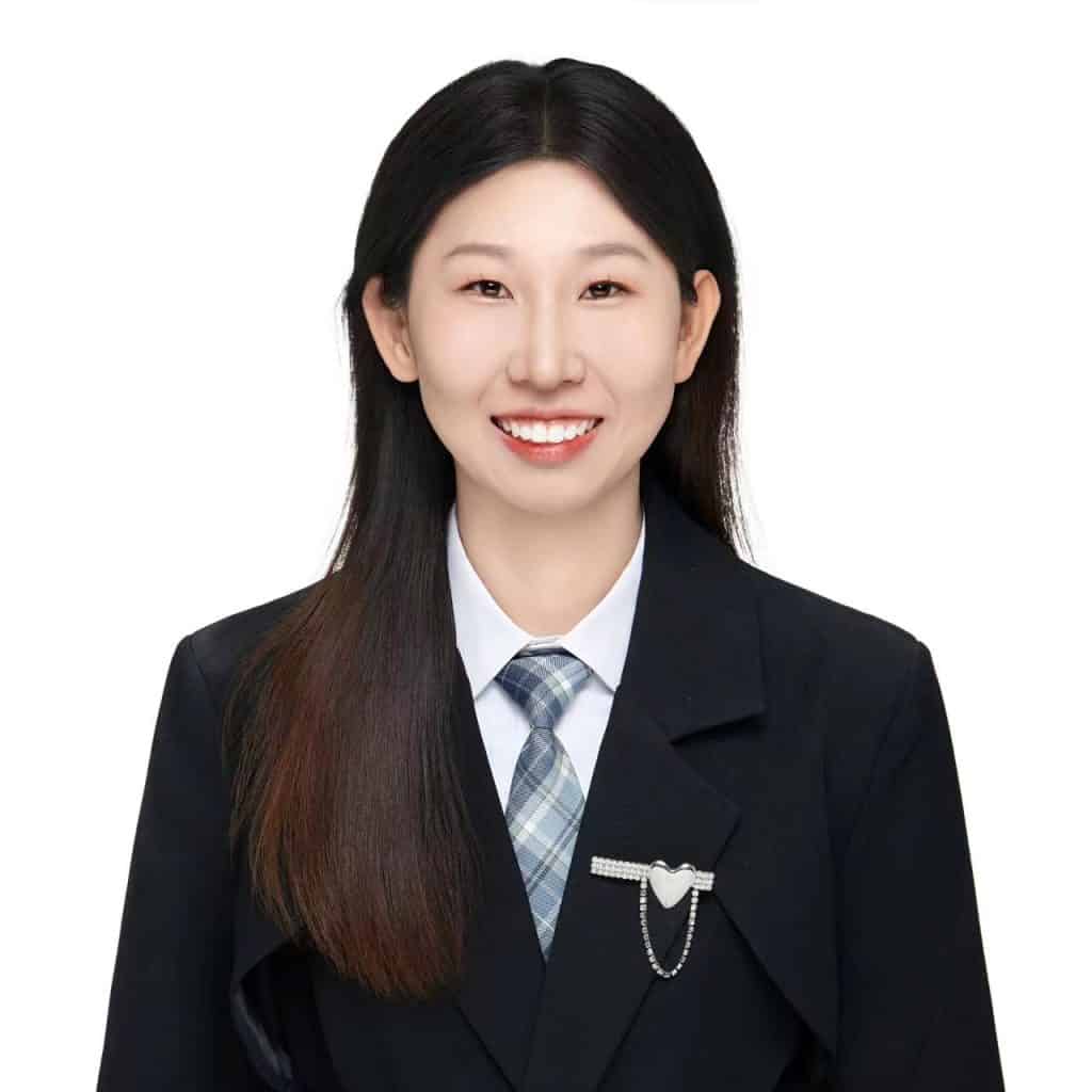 Professional headshot of Audrey, sales representative at Vastlog, wearing a beige blazer and pearl earrings, posed against a plain background
