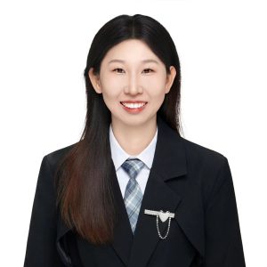 Professional headshot of Audrey, sales representative at Vastlog, wearing a beige blazer and pearl earrings, posed against a plain background