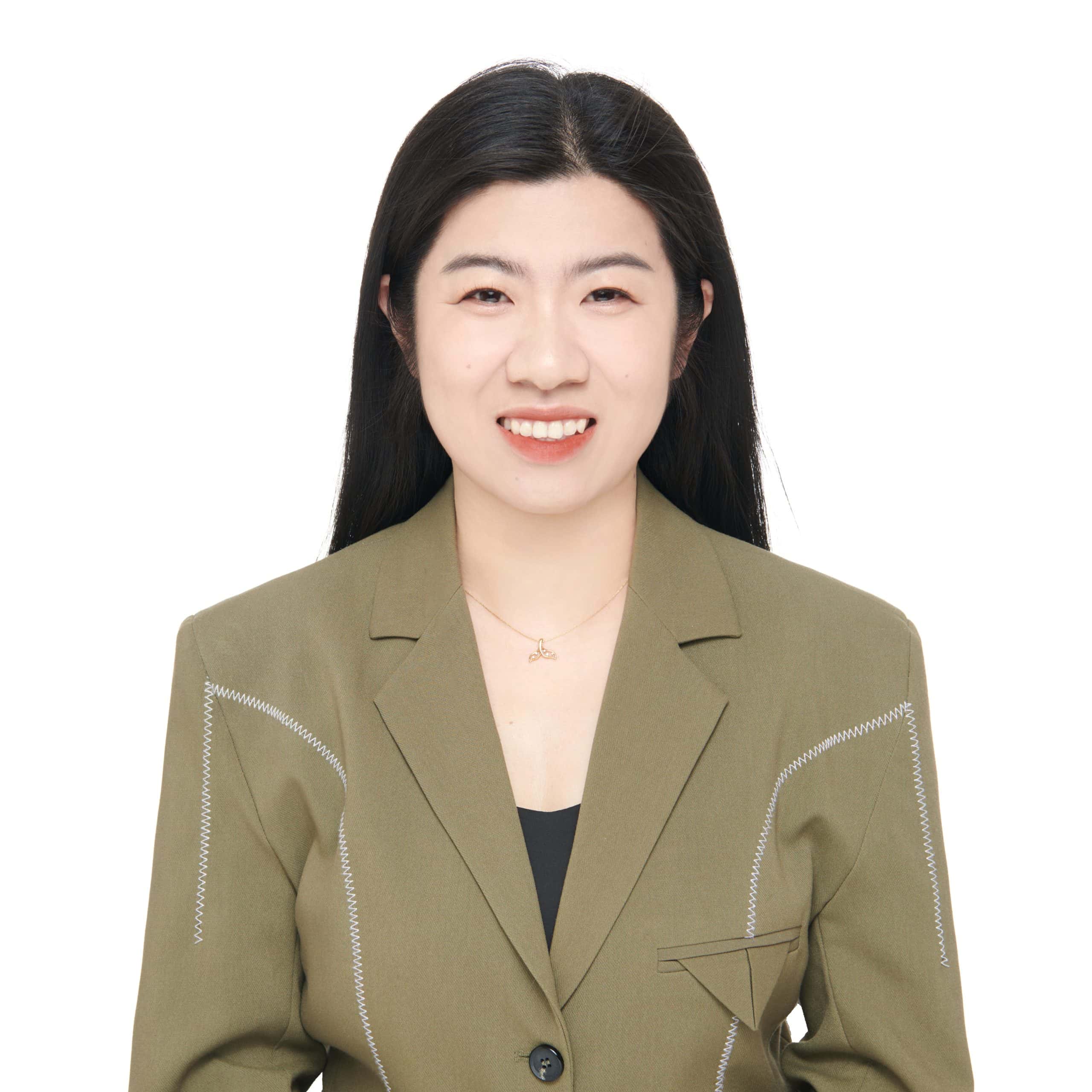 Professional headshot of Jessy, sales representative at Vastlog, wearing an olive green blazer and black top, smiling against a plain background