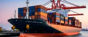 Container cargo ship at port with stacked shipping containers and cranes, representing China Vast Logistics services for global freight forwarding.