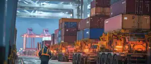 Container terminal in China with cargo ships and logistics equipment, showcasing Vast Logistics' expertise in freight forwarding and supply chain solutions.