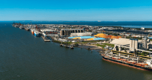 Vast Logistics China port and shipping infrastructure at a major industrial harbor with cargo ships and warehouses for efficient freight forwarding and supply chain management.