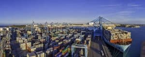 Large container port with cargo ships, cranes, and stacked containers showcasing China's vast logistics infrastructure for international shipping and freight transportation.