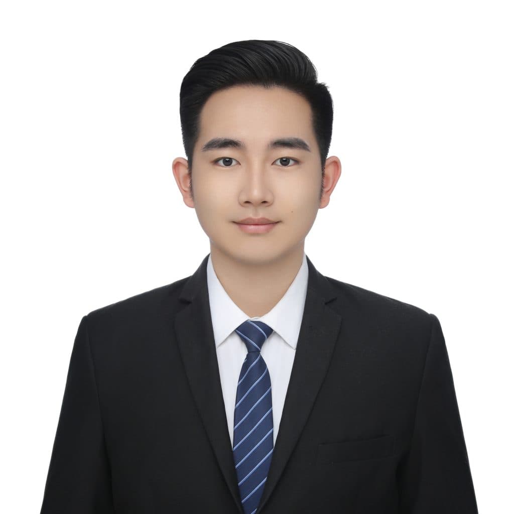 Professional headshot of Ryan Ren, sales representative at Vastlog, wearing a black suit, white shirt, and striped tie, posed against a plain background