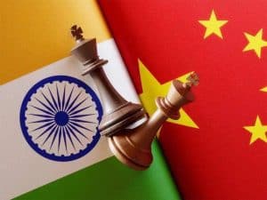 Chess pieces on Indian and Chinese flags, symbolizing strategic global logistics and international trade connections between India and China.