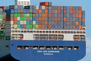 Intermodal cargo ship carrying colorful shipping containers docked at port, representing global logistics, transportation, and maritime shipping services from China Vast Logistics.