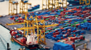 Large cargo containers and cranes at a busy Asian port, highlighting China Vast Logistics' role in global freight shipping and cargo logistics.