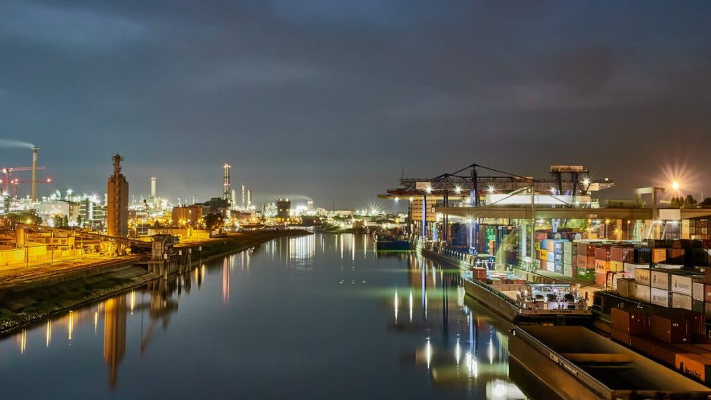 Illuminated container terminal and stacked cargo containers at night